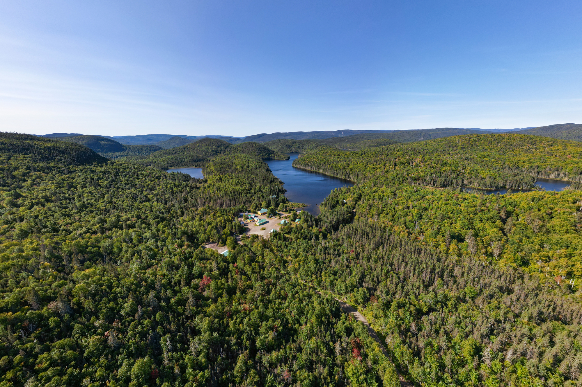 Aerial view of lush forests and lakes surrounding Pourvoirie du Lac Croche in Charlevoix's wilderness region